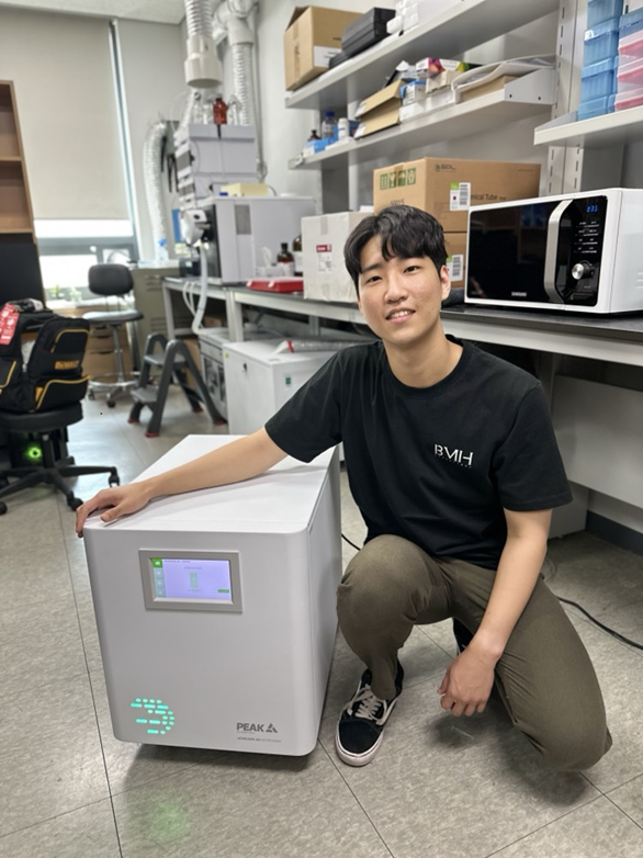 Scientist sitting beside his Horizen 24 nitrogen gas generator