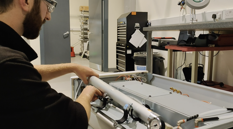 Engineer replacing parts in a PEAK gas generator